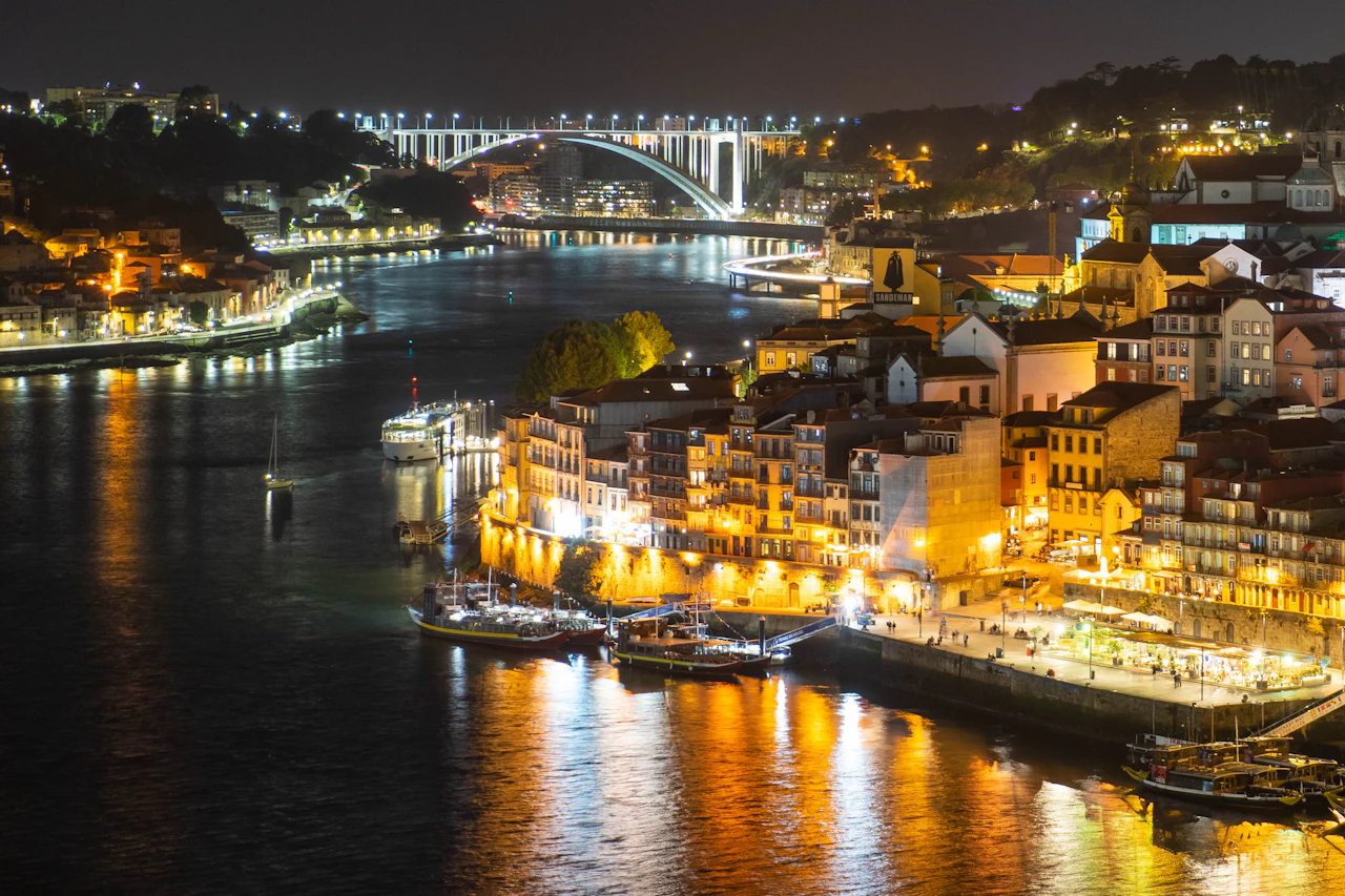 Illuminated Ribeira waterfront and Dom Luís I bridge at night