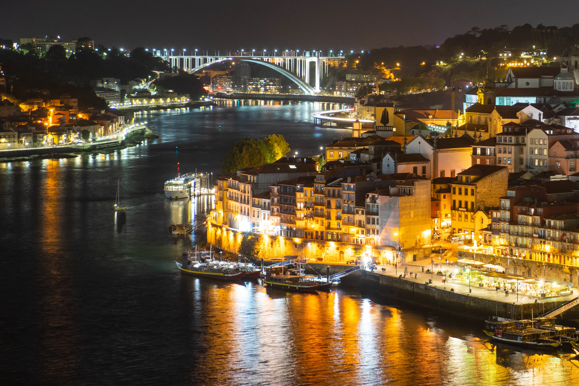 Illuminated Ribeira waterfront and Dom Luís I bridge at night